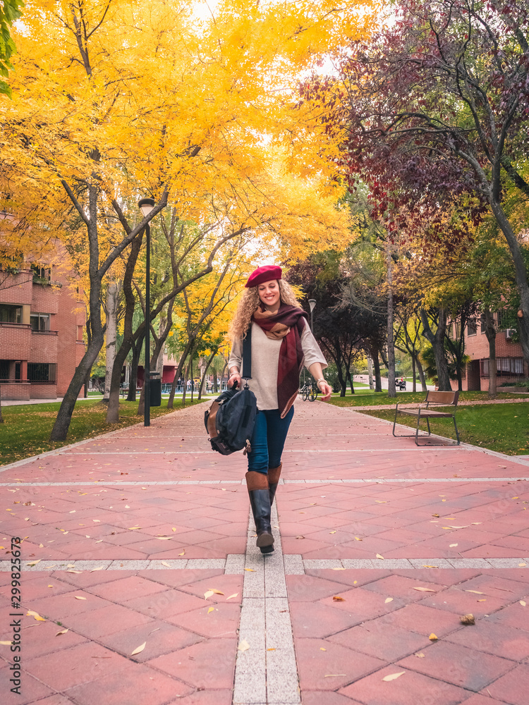 Fototapeta premium young travel woman in autumn outfit smiling looking at pretty autumn colours