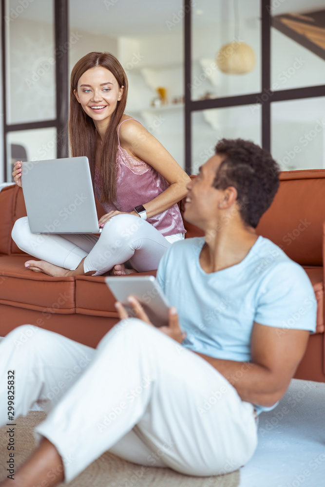 Positive delighted couple looking at each other Positive delighted couple looking at each other