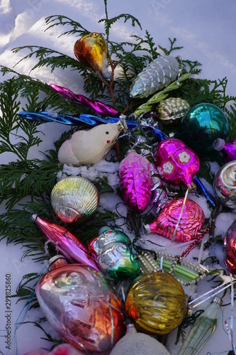 Vintage glass Christmas tree toys in the snow.