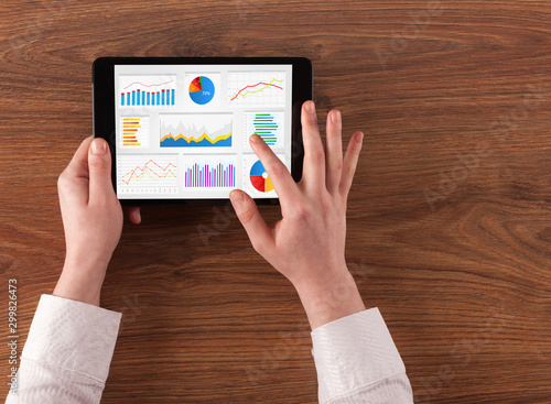 Hand making diagrams and charts on tablet