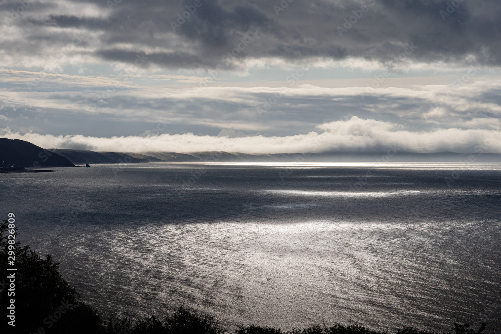 Obraz premium Mist and cloud over Cornwall flowing into the sea on the south Cornish cost in Whitsand bay