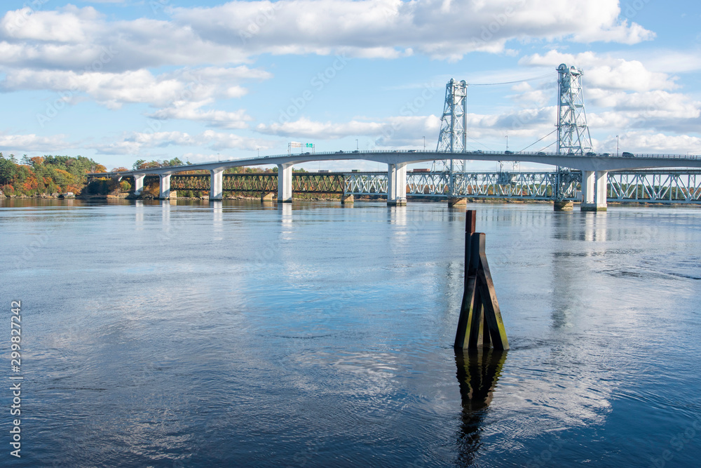 Fototapeta premium View of bridge over Kennebec river in Bath, Maine On A Sunny Afternoon with light clouds in sky.