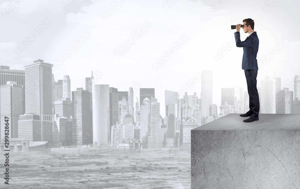 Young investor looking to the city from distance and thinking about investment Young investor looking to the city from distance and thinking about investment