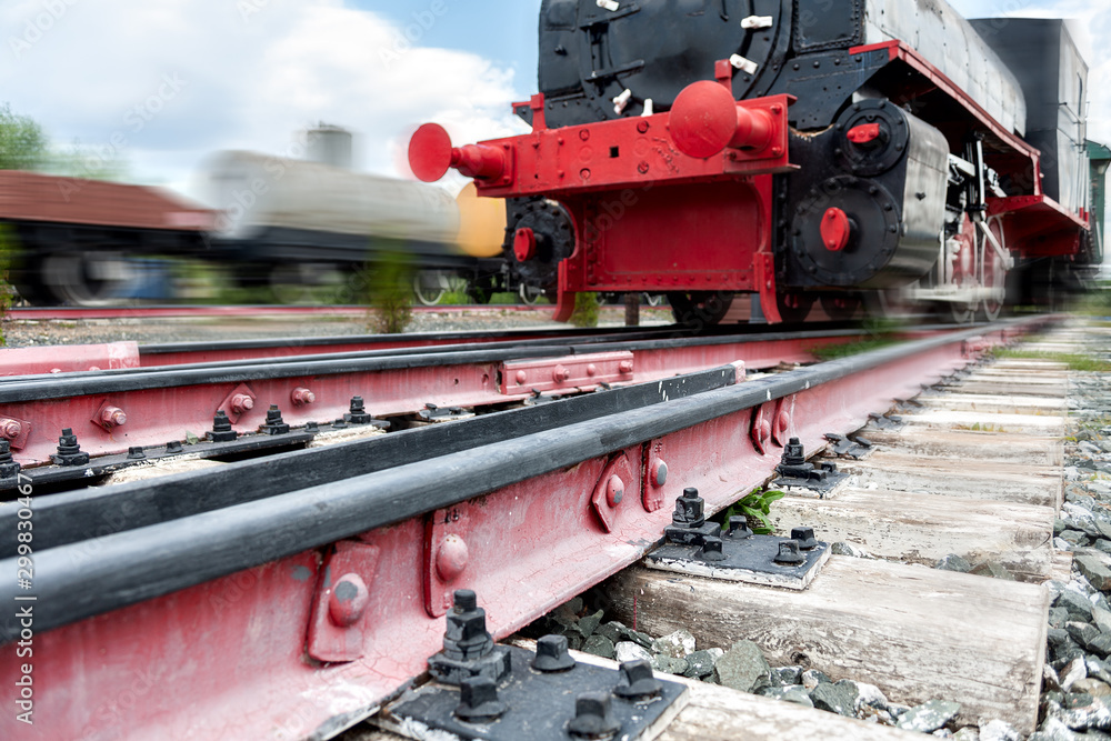 Naklejka premium rails for trains close-up selective focus, against the background of the train coming towards, safety on the railway, the danger of railway crossings