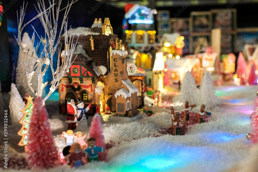 christmas time, miniature of houses and people, winter and snow at night, xmas houses decorated with lights 