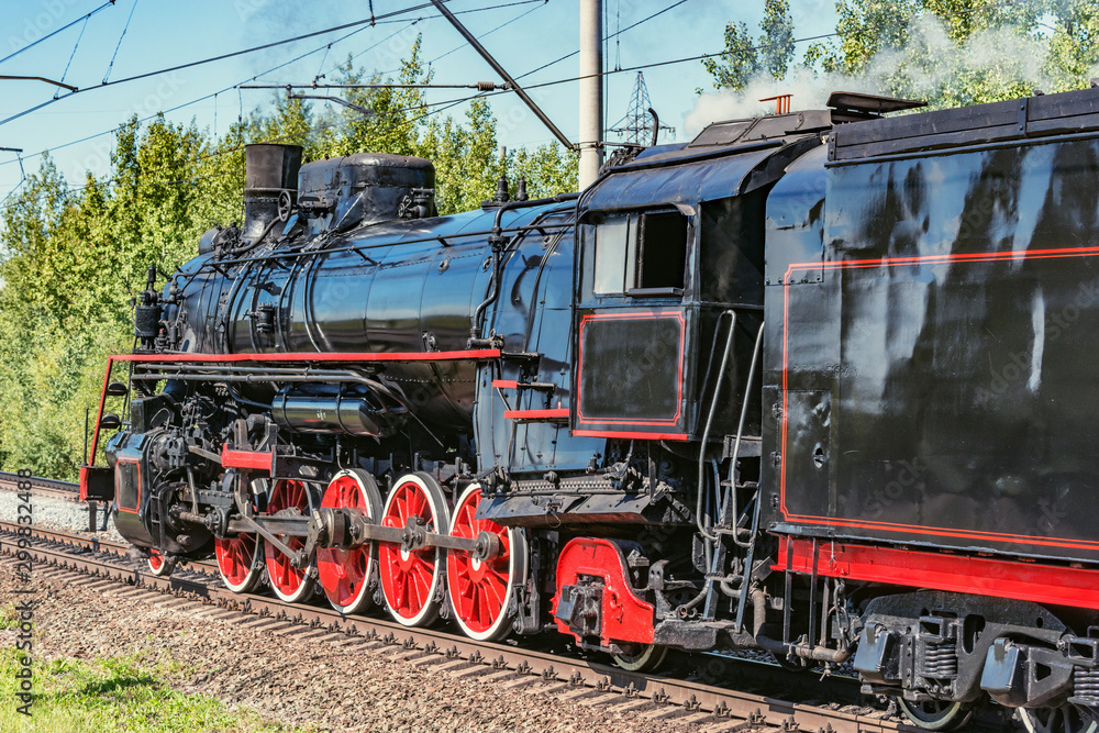 Fototapeta premium Retro steam freight train departs from the railway station. Moscow. Russia.
