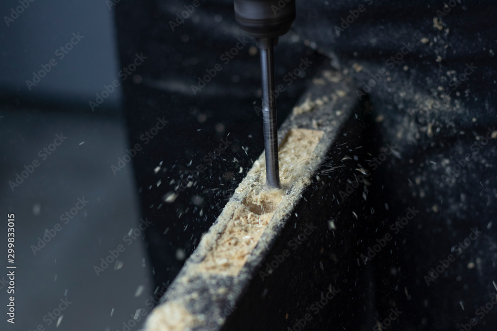 Installing a door, Install a door lock, use a milling saw, a carpenter close-up holds a green electric drill Installing a door, Install a door lock, use a milling saw, a carpenter close-up holds a green electric drill