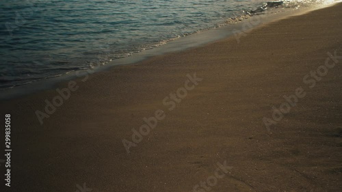 Wallpaper Mural Waves calmly washing on a sandy beach with afternoon sun reflection Torontodigital.ca