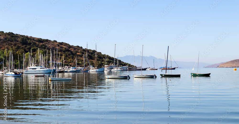 Calm blue bay in Mediterranean. Holiday and relaxation on sea coast. Beautiful reflection in the calm water of the sea