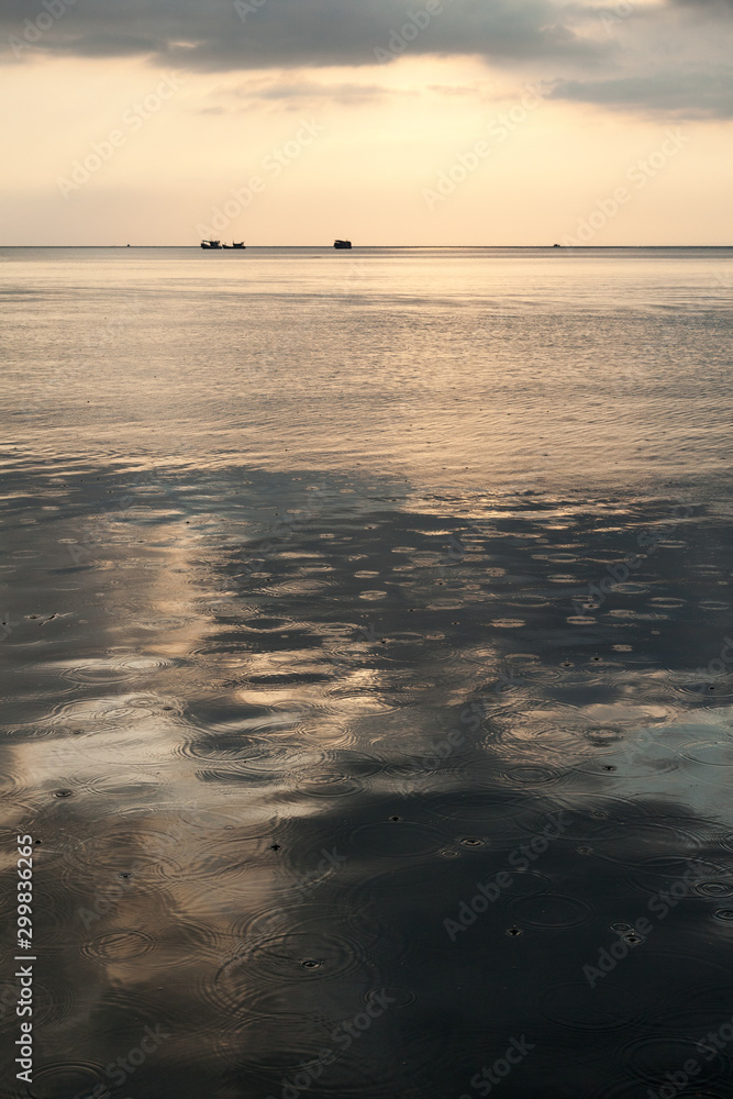 Fototapeta premium Calm sea at dawn with raindrops on the water surface, Koh Rong island, Cambodia.