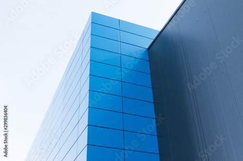 Geometric colored building facade elements with planes  lines and corners with light flare and reflections for an abstract background and texture of white  blue  gray colors. Place for text