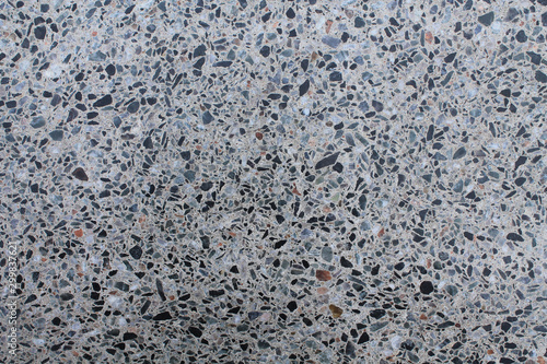 Granite wall structure. Small multi-colored stones polished surface. Texture for design.