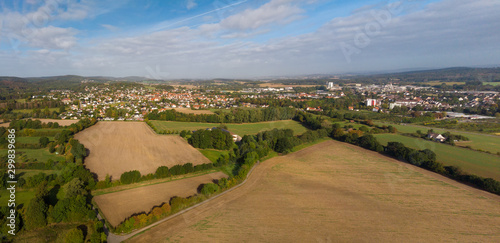 Drone footage of the small East Westphalian German town Horn. In the foreground fields of agriculture and in the background the city with the industrial area on the right.