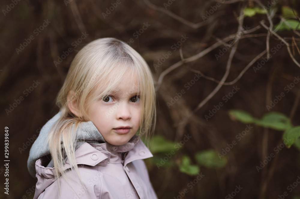 Portrait of staring little girl in the woods Portrait of staring little girl in the woods