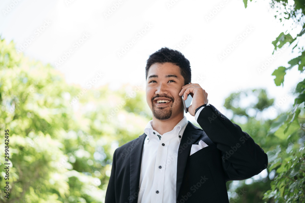 Portrait of young businessman talking on the phone outdoors Portrait of young businessman talking on the phone outdoors