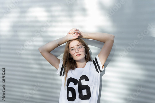 Portrait of young woman, wearing t-shirt with number 66 photo