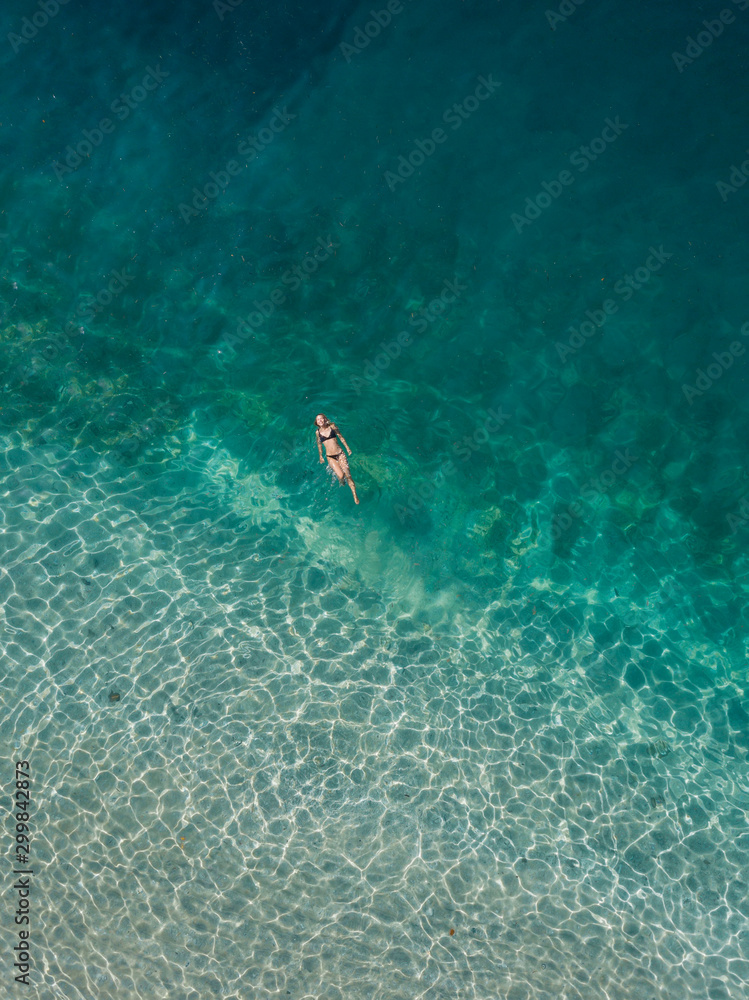 Woman floating in the sea, Gili Air, Gili Islands, Indonesia