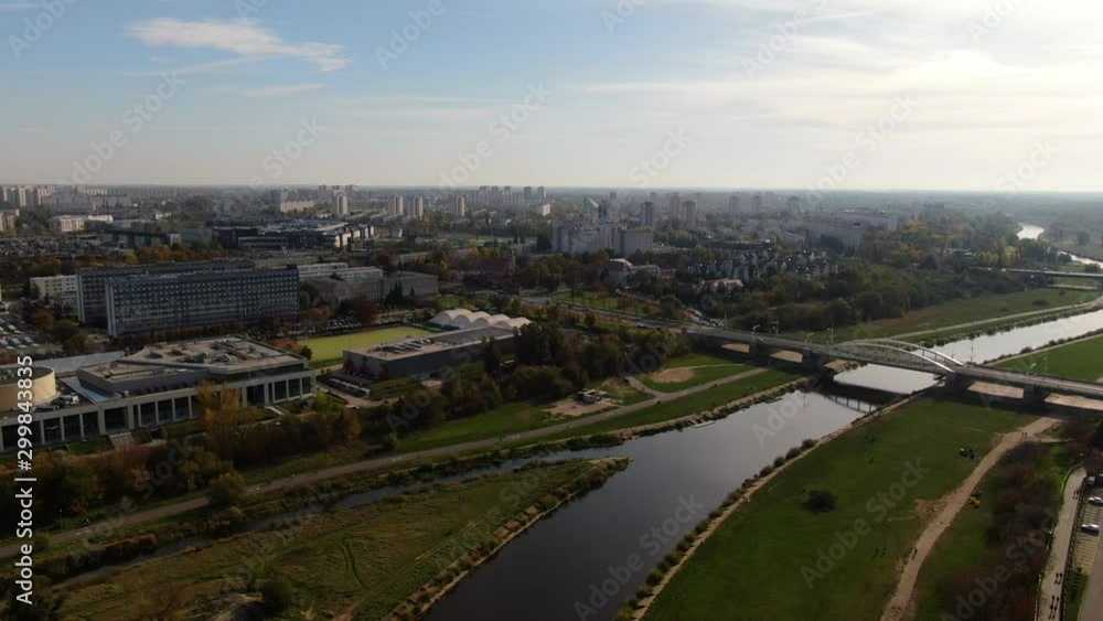 Aerial drone shot flying above Warta River and city Poznan Poland and in sunny day.