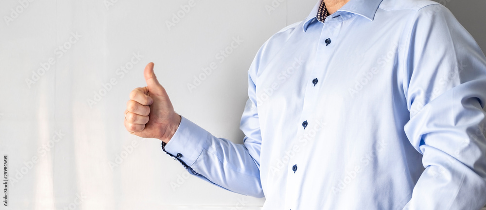 A man in a blue shirt shows a finger to the top. Like and good mood, positive emotions. A man in a blue shirt shows a finger to the top. Like and good mood, positive emotions.