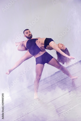 Two Young modern dancers dancing in the studio. Sport, dancing and urban culture concept. Group of young dancers performing on the stage. Effective performance. beautiful dance. 