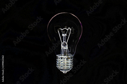 Transparent holographic incandescent lamp bulb on black background