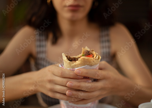 woman eating kebab, fast food