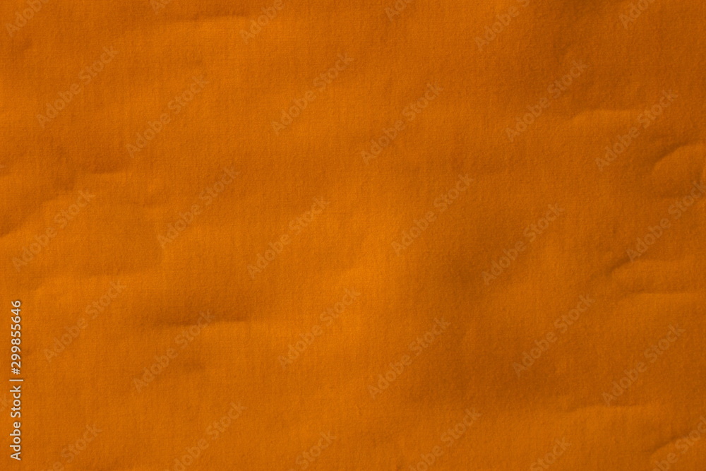 Real orange canvas with wrinkles as a background.
