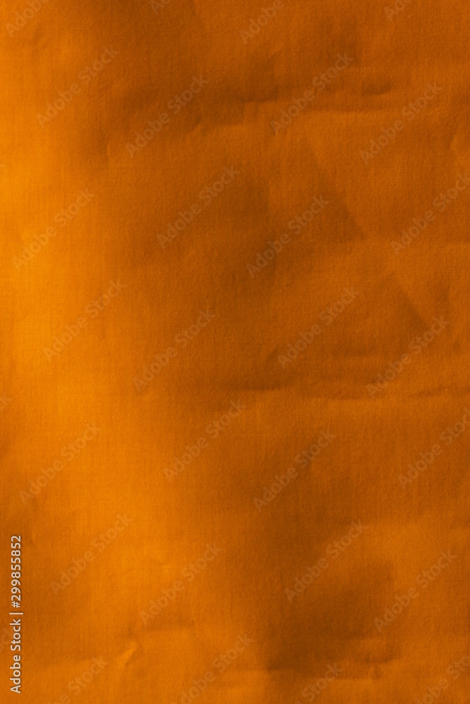Real orange canvas with wrinkles as a background.