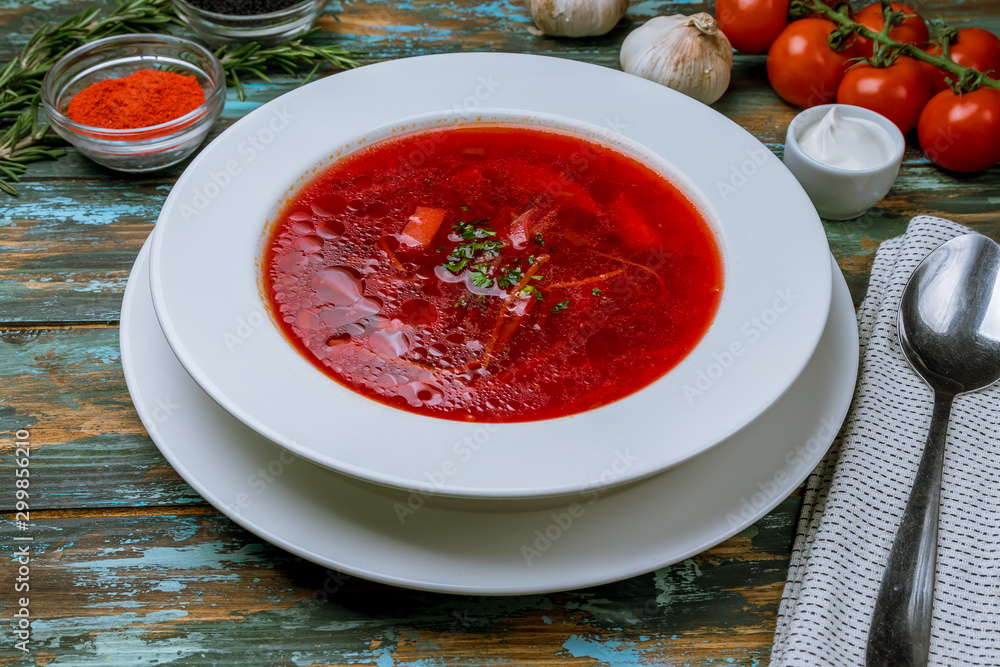 Borscht with sour cream on wooden table Borscht with sour cream on wooden table