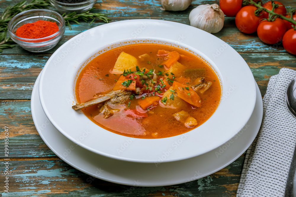 shurpa asian soup on wooden table shurpa asian soup on wooden table