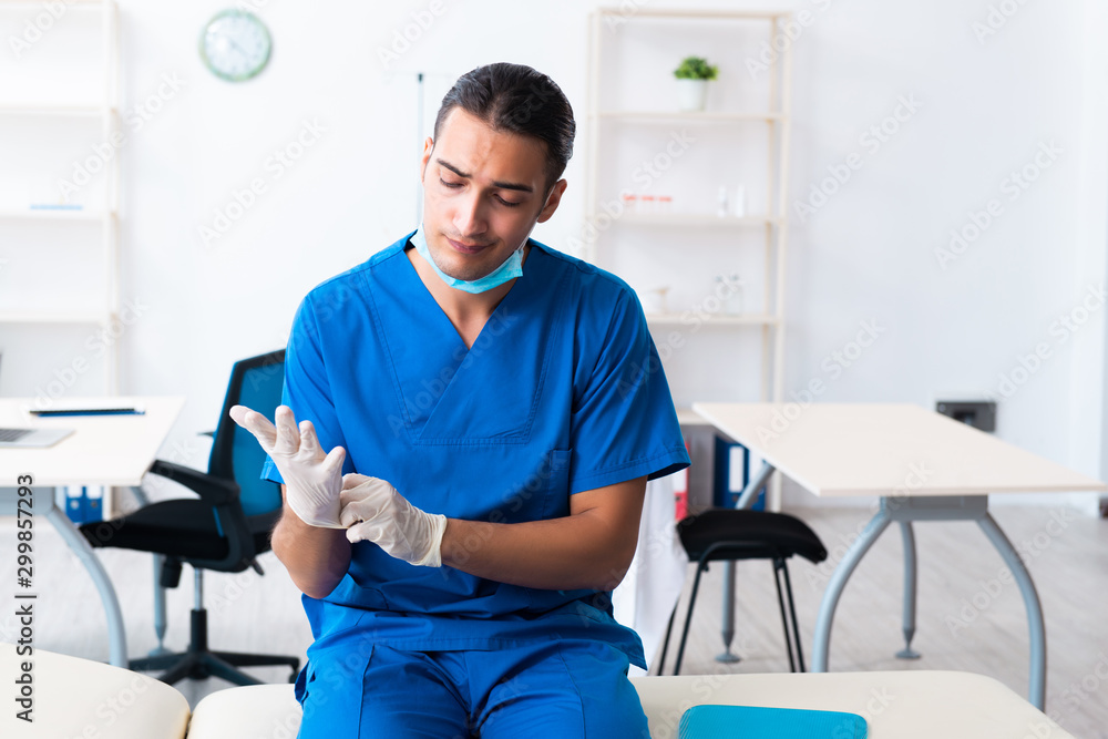 Young male doctor working in the clinic Young male doctor working in the clinic