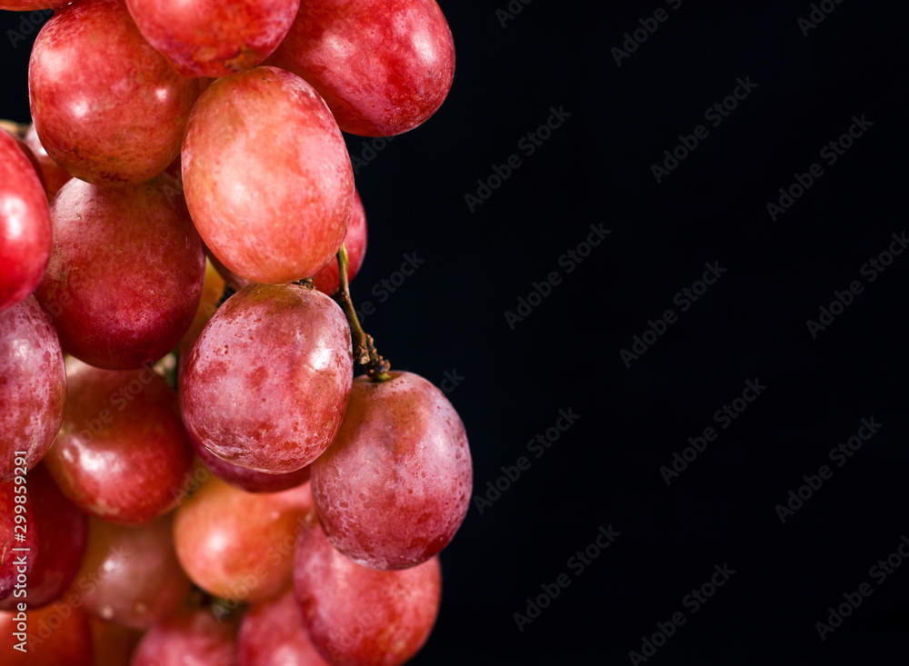 Bunch of red grapes isolated on a black background Bunch of red grapes isolated on a black background