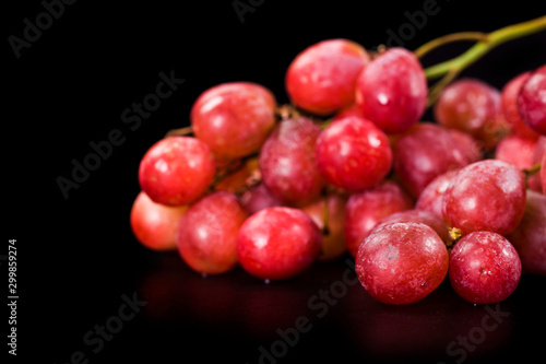 Bunch of big red grapes isolated on a black background