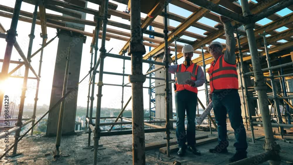 Construction workers are discussing the building site