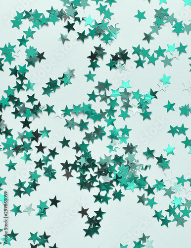 Festive background. Colorful glitter stars on mint color background. © Alona