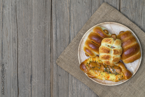 various fresh cheese sausage bread with sack on wooden background,top view
