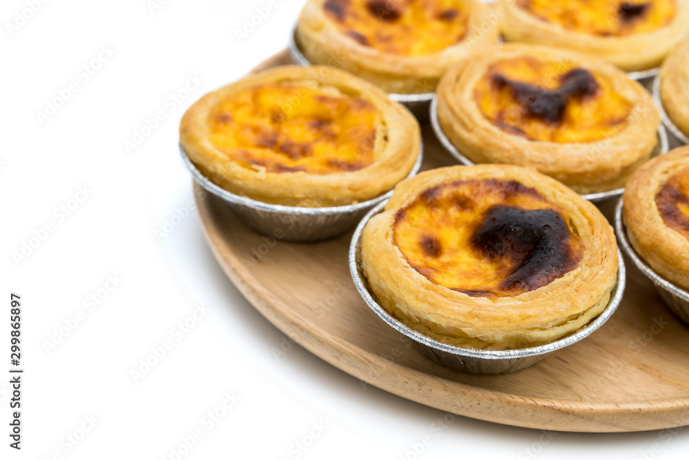 egg tart in aluminum foil cup isolated on white background egg tart in aluminum foil cup isolated on white background