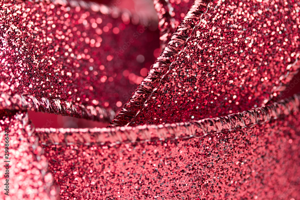 Macro abstract texture view of glittering defocused red fabric ribbon with bokeh Macro abstract texture view of glittering defocused red fabric ribbon with bokeh