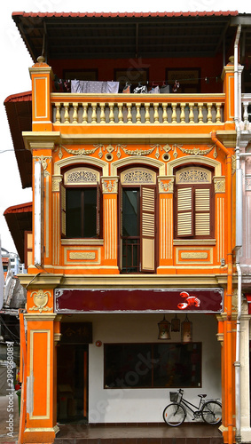 Canvas Print Orange restored peranakan Chinese shop house.