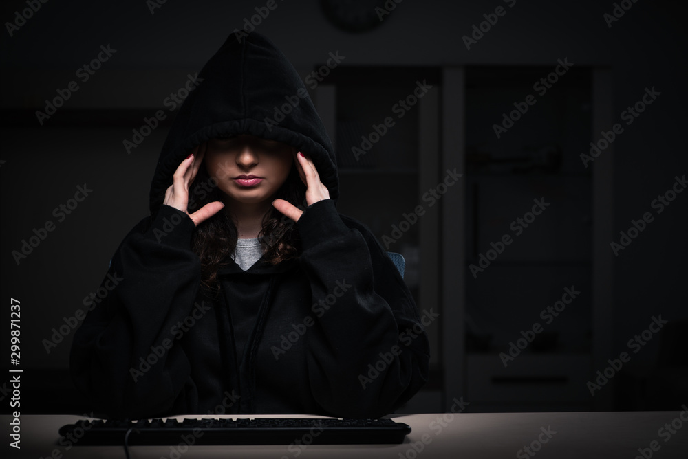 Female hacker hacking security firewall late in office Female hacker hacking security firewall late in office