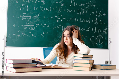 Young female math teacher in front of chalkboard