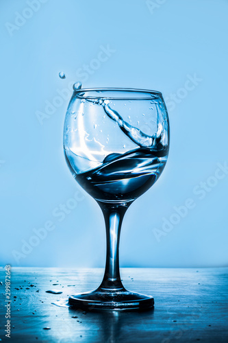 Glass of martini splash on a blue background