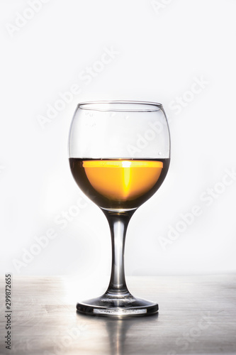 Amber wine. Liquid in a glass. Traditional wine according to ancient Georgian technology. Copy space Macro and vertical orientation.