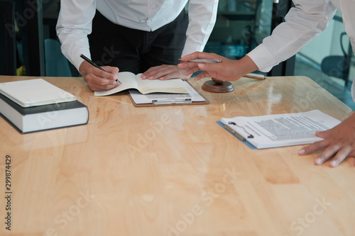 lawyer give advice to man. businessman discussing legal legislation at law firm. judge team meeting at courtroom photo