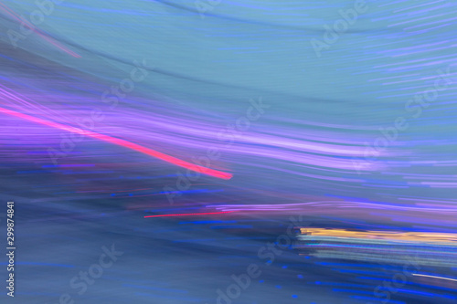 Abstract background of blue and violet light bulbs in motion