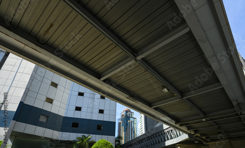 (Selective focus) Stunning view of a modern building in Kuala Lumpur with an overpass in the foreground. Kuala Lumpur commonly known as KL, is the national capital and largest city in Malaysia.