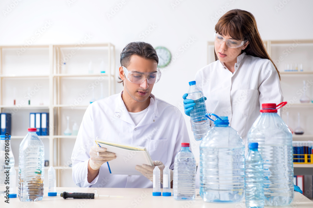 Two chemists working in the lab Two chemists working in the lab