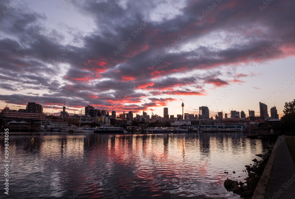 Fototapeta premium pink and grey sunrise clouds and cityscape