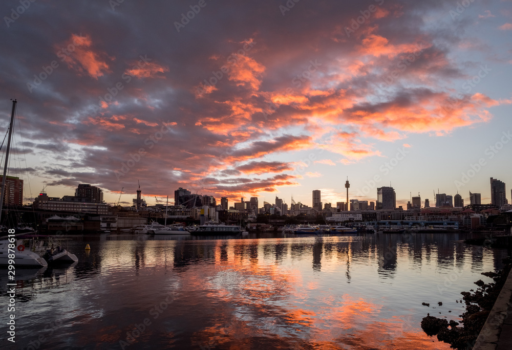 orange and grey clouds over cityscape at sunrise