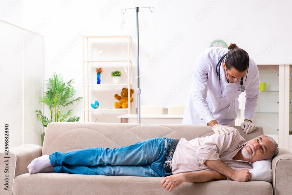 Young male doctor visiting old patient at home Young male doctor visiting old patient at home
